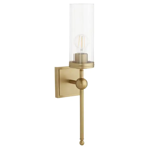 The Lee Boulevard wall sconce blends traditional elegance with contemporary spherical details and vertically-fluted clear glass. Inspired by a Kansas City countryside home, it offers transitional comfort with aged brass warmth.