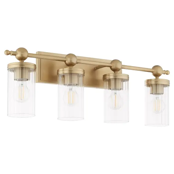 The Lee Boulevard 4-Light Vanity combines traditional elegance with contemporary spherical details and vertically-fluted clear glass shades. Inspired by a Kansas City countryside home, this fixture offers transitional comfort with aged brass finish and modern beaded elements for a luxurious bathroom upgrade.