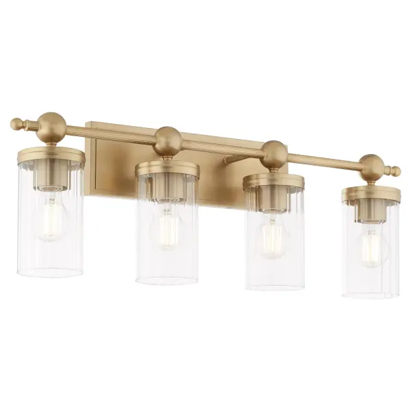 The Lee Boulevard 4-Light Vanity combines traditional elegance with contemporary spherical details and vertically-fluted clear glass shades. Inspired by a Kansas City countryside home, this fixture offers transitional comfort with aged brass finish and modern beaded elements for a luxurious bathroom upgrade. - alternate view