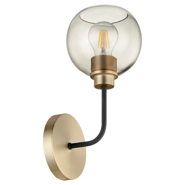 The Clarion wall sconce combines flowing curves with angular forms, featuring a sophisticated textured black and aged brass finish. The smoke glass shade provides soft, diffused lighting perfect for ambient illumination.