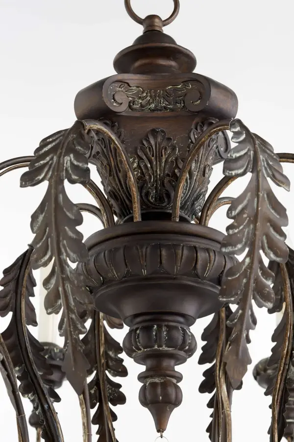 The Salento chandelier brings Italian Baroque and Rococo influences to life with gracefully curved arms, candlestick-styled lights, and vintage copper finish. Its 8-light design offers substantial illumination while leaf motifs add artisanal character. - alternate view
