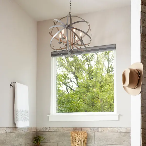 The Celeste chandelier combines futuristic metal ring architecture with traditional candelabra bulbs, creating a versatile transitional piece. Its zinc finish and geometric structure add contemporary edge while maintaining timeless appeal. - alternate view
