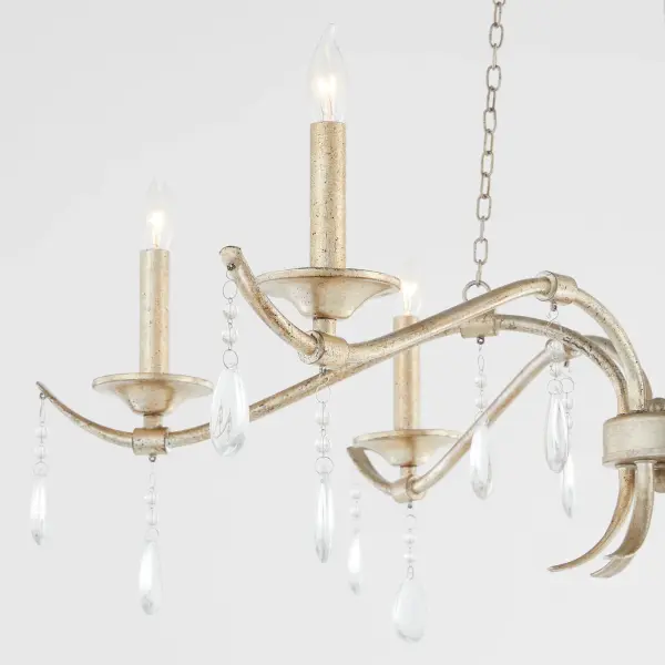 The Lorelei chandelier combines refined elegance with luxurious crystal detailing. Its aged silver leaf finish and sweeping curves create a sophisticated focal point, while cascading crystals add sparkle and movement to any space. - alternate view