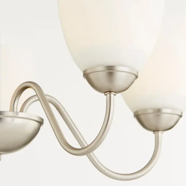 This 5-light chandelier combines graceful curves with a sleek satin nickel finish, delivering classic traditional style at an accessible price point. Perfect for dining rooms and entryways seeking timeless charm. - alternate view