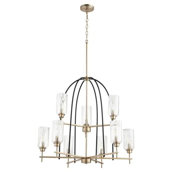 The Espy 9-Light Chandelier combines geometric Art Deco styling with contemporary linear framing. Clear fluted glass shades and two-toned noir/aged brass finishes create refined accent lighting for upscale interiors.