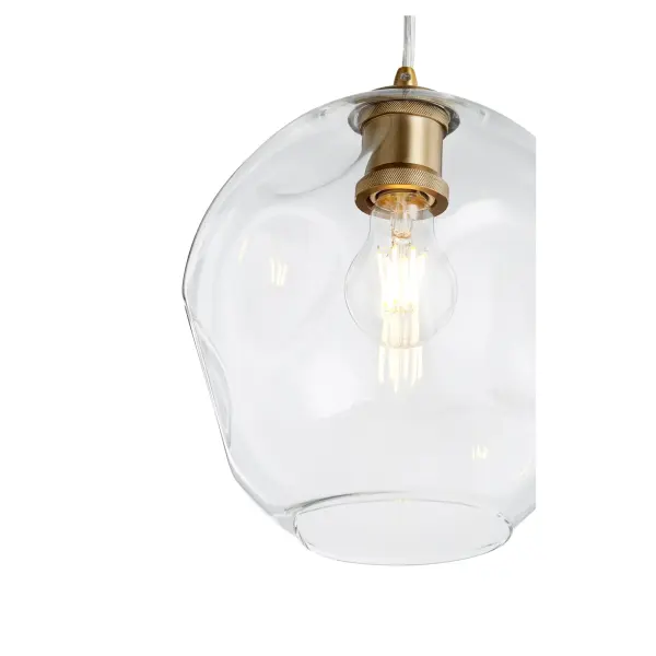 The Numen pendant combines modern sophistication with timeless brass warmth. Its distinctive wavy glass globe creates beautiful light diffusion while the aged brass finish adds character to any space. - alternate view