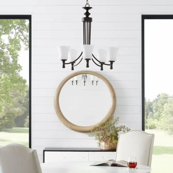 The Rossington 5-Light Chandelier bridges traditional and contemporary design with clean lines, soft curves, and a rich Oiled Bronze finish. Its Satin Opal glass shades provide warm, diffused lighting perfect for dining rooms and entryways. - alternate view