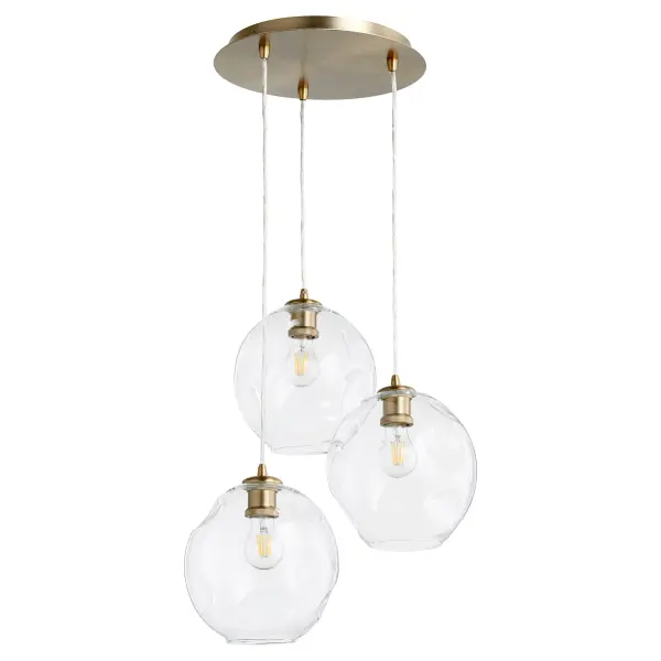The Numen 3-Light Pendant Cluster combines streamlined cylindrical forms with lustrous aged brass and distinctive wavy glass shades. Perfect for adding contemporary sophistication to dining areas and kitchen islands with adjustable height flexibility.