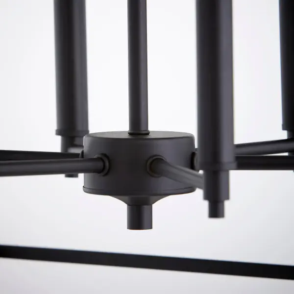The Gabriel chandelier delivers minimal elegance with maximum versatility. Its clean-lined Noir finish pairs beautifully with three included candle sleeve options (Noir, Satin Nickel, Aged Brass), allowing you to customize the look to match evolving décor. Perfect for kitchen islands, dining rooms, or foyers. - alternate view