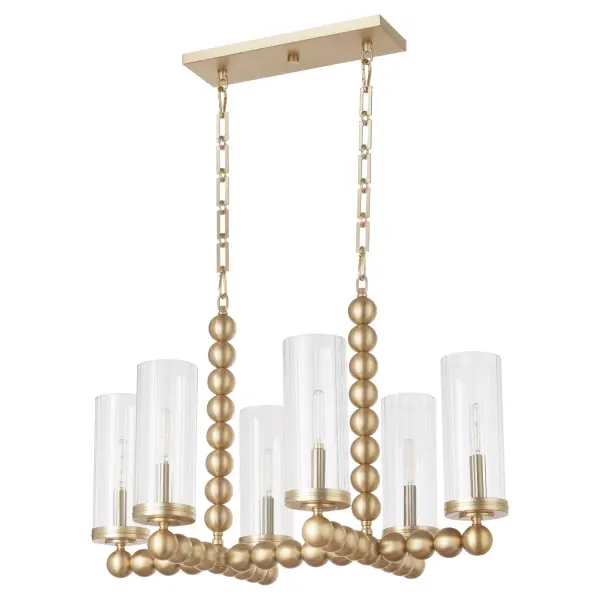 The Lee Boulevard linear chandelier blends traditional warmth with contemporary spherical details and fluted glass shades. Inspired by a Kansas City countryside home, this 6-light fixture offers luxurious transitional style in aged brass.