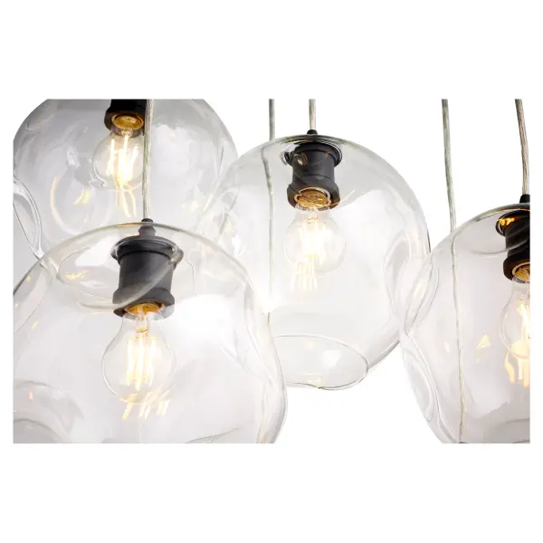 The Numen pendant cluster delivers bold contemporary style with seven streamlined cylindrical fixtures in lustrous Noir black finish. Clear wavy glass globes create beautiful light diffusion while adjustable cords allow perfect height customization. - alternate view
