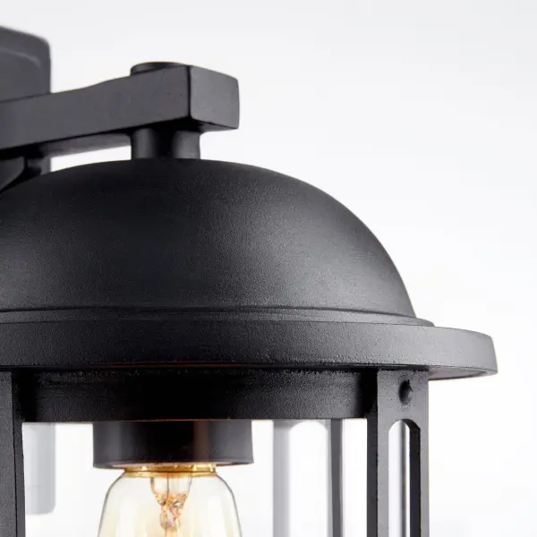 This 13-inch outdoor wall light combines timeless transitional design with practical wet-rated performance. The black finish and clear seeded glass cylinder create warm ambient lighting perfect for covered outdoor spaces. - alternate view