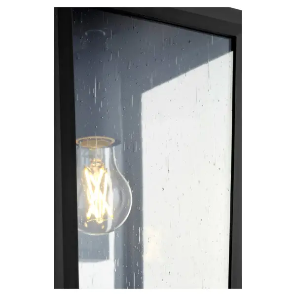 The Bravo outdoor wall lantern combines coastal durability with geometric mid-century design. Wet-listed and constructed from marine-grade materials, it features clear seeded glass panels and a sharp black finish. - alternate view