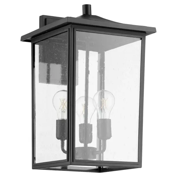 The Riverside outdoor wall lantern combines traditional design with transitional versatility. Featuring a noir black finish and clear seeded glass panels, it delivers warm ambient lighting for covered outdoor spaces.