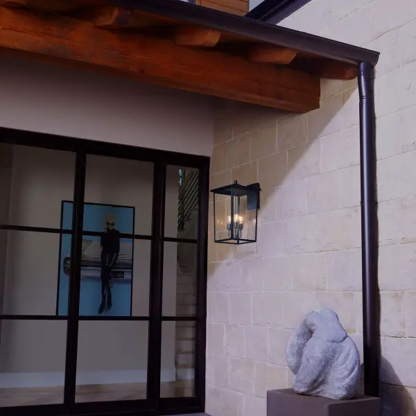 The Riverside outdoor wall lantern combines timeless design with modern functionality. Featuring a noir black finish and clear seeded glass panels, this wet-rated fixture delivers both style and durability for covered outdoor spaces. - alternate view