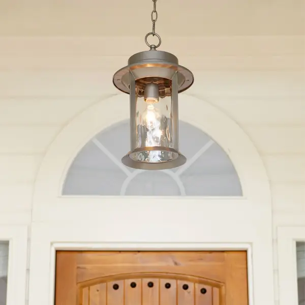 The Charter pendant combines clean-lined transitional design with outdoor durability. Its 16" drum silhouette features hammered glass panels that diffuse light beautifully while the graphite metal frame adds modern sophistication to porches and entryways. - alternate view