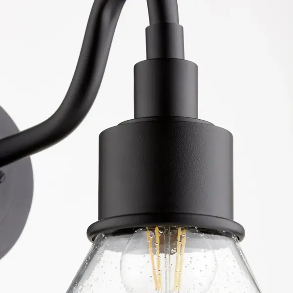 The Torrey lantern combines industrial and rustic elements with a noir black finish and clear seeded glass. Its Wet rating makes it ideal for outdoor applications while maintaining indoor versatility. - alternate view