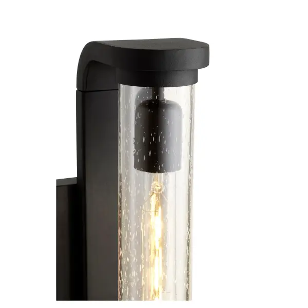 The Vitro wall lantern combines contemporary minimalist design with maximum light output. Its tall, curved form and clear-seeded glass diffuser create a striking accent for modern outdoor spaces while providing excellent illumination. - alternate view
