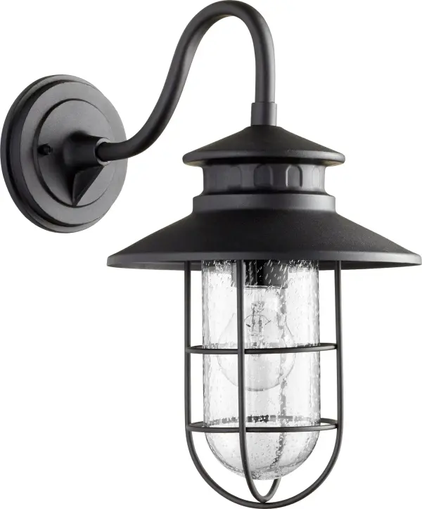 The Moriarty 16" wall light combines coastal charm with rustic durability. Its caged clear glass design provides welcoming illumination while the black finish ensures easy maintenance for outdoor environments.