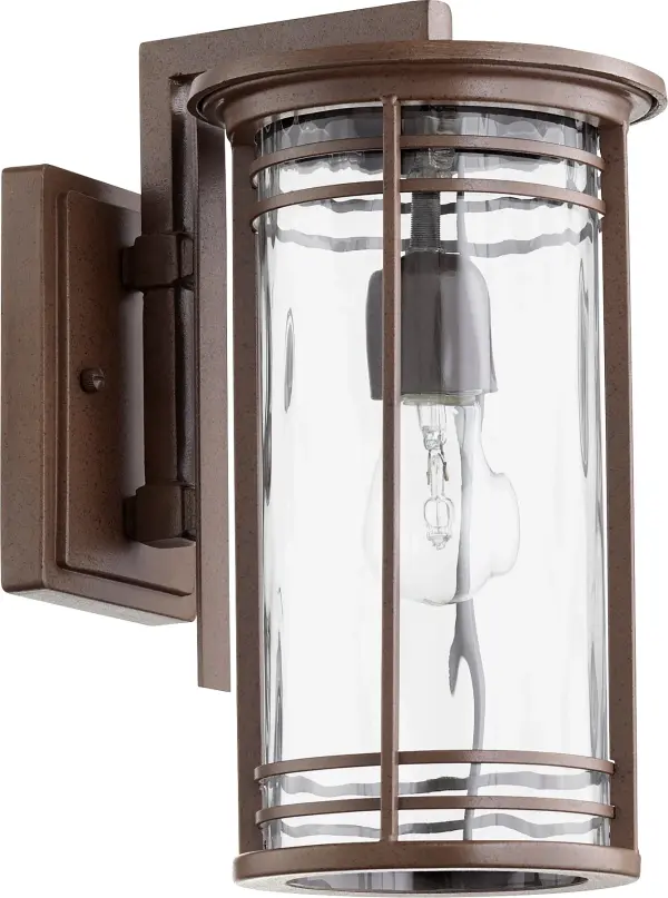 The Larson outdoor wall light combines clean contemporary lines with practical durability. Its elongated drum silhouette and clear hammered glass create beautiful ambient lighting while the wet-listed rating ensures reliable performance in exposed outdoor conditions.