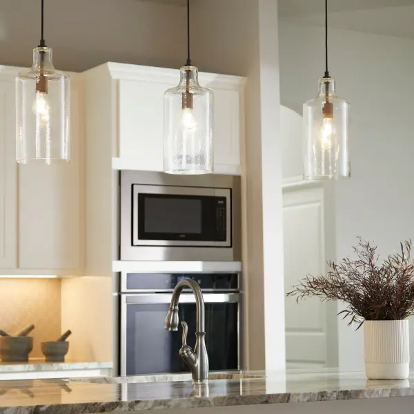 This transitional pendant features artful hammered glass that creates a luminous glow, paired with a sophisticated noir black finish. The 10-foot adjustable cord makes it adaptable to various ceiling heights and spaces. - alternate view
