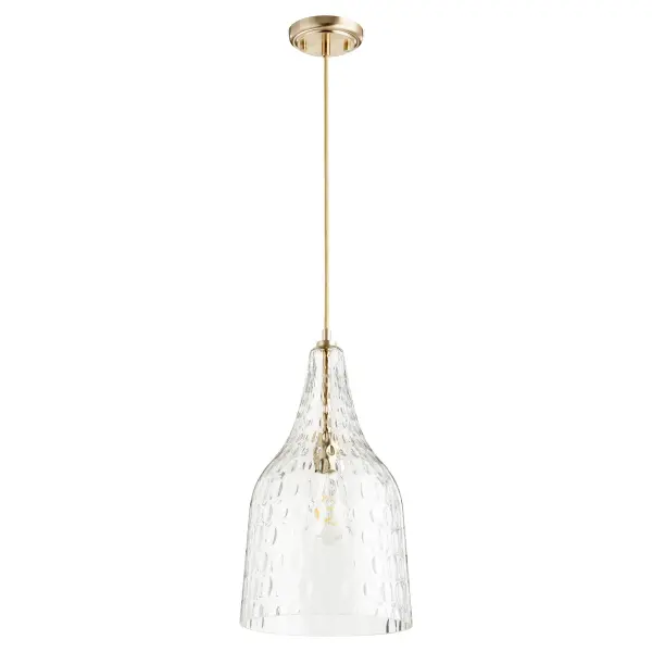 This transitional pendant combines artisanal hammered glass with warm aged brass for a luminous, textured glow. The adjustable 10-foot cord offers installation flexibility for various ceiling heights.