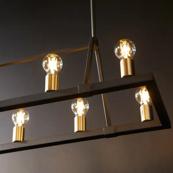 The Paxton combines rustic charm with contemporary geometry in a stunning 10-light linear design. Its two-tone Noir and Aged Brass finish creates visual interest while exposed bulbs add industrial appeal. Damp-rated for versatility. - alternate view