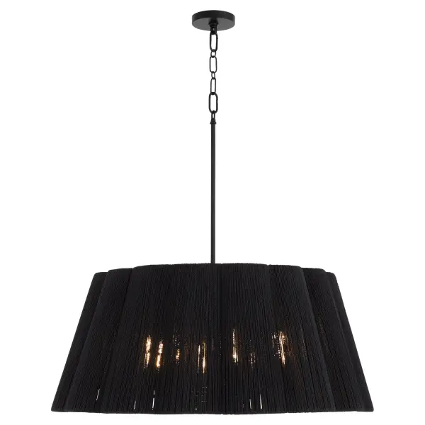 The Anton 8-Light Pendant combines organic natural fiber with a sleek matte black finish, creating a sophisticated focal point. Its scalloped drum shade diffuses light beautifully while the Figaro chain adds refined detail. - alternate view