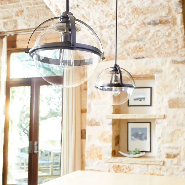 This versatile pendant features a clear glass sphere suspended in a refined satin nickel frame, offering clean lines and luminous clarity. Adjustable rod options accommodate various ceiling heights and slopes, making it adaptable to diverse spaces. - alternate view