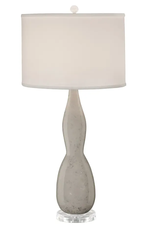 The Mercury table lamp combines artisanal craftsmanship with transitional elegance. Its glazed ceramic body features hand-painted silver overglaze accents on an acrylic base, topped with a white silk drum shade for refined ambient lighting.