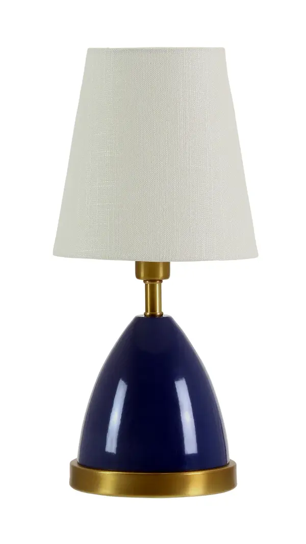 The Geo Parabola Mini Accent Lamp brings contemporary geometric design to compact spaces. At just 12" tall, this petite fixture features a striking navy blue finish with weathered brass accents and a linen shade, perfect for adding sophisticated task or ambient lighting to bedside tables, desks, or accent surfaces.