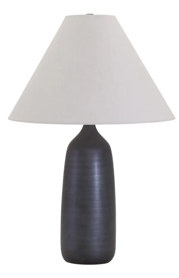 The Scatchard table lamp combines artisanal ceramic craftsmanship with a sophisticated black matte finish. At 25" tall with a generous 17" shade, it provides substantial presence and ambient lighting for living spaces.