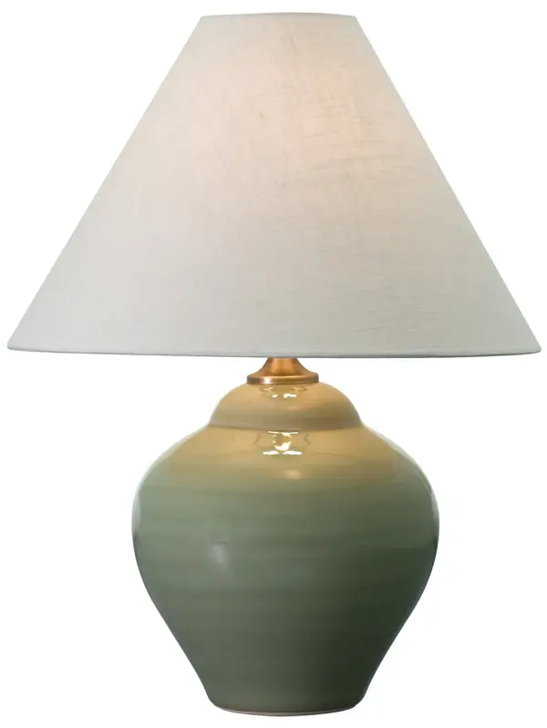 The Scatchard table lamp combines traditional ceramic craftsmanship with a soft celadon glaze, creating a versatile accent piece. At 21.5 inches tall with a cream linen shade, it provides warm ambient lighting for bedrooms and living spaces.