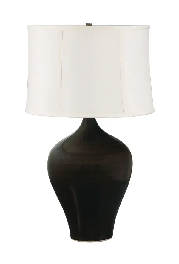 The Scatchard table lamp combines artisanal ceramic craftsmanship with transitional styling. Its substantial 25-inch height and rich brown gloss finish make it a statement piece for living spaces and bedrooms.