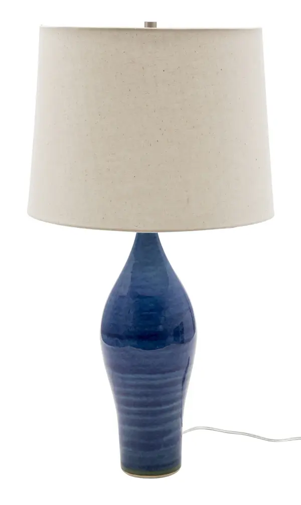 The Scatchard table lamp combines timeless ceramic craftsmanship with a striking blue gloss finish. At 27" tall with a generous 15" shade, it provides substantial presence and ample illumination for any space.