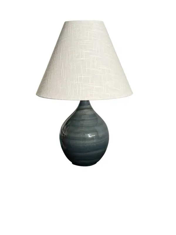 The Scatchard table lamp combines artisanal ceramic craftsmanship with a sophisticated slate finish. Its 19-inch height and cream linen shade create warm, ambient lighting perfect for residential and hospitality settings.