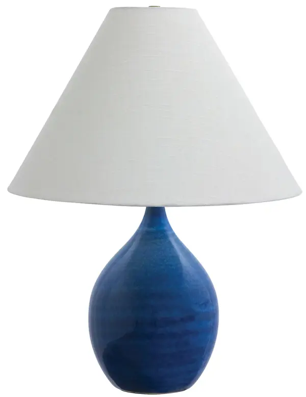 The Scatchard table lamp combines timeless ceramic craftsmanship with a vibrant blue gloss finish. At 22.5 inches tall with a generous 17-inch shade, it provides substantial lighting and visual presence for medium to large spaces.