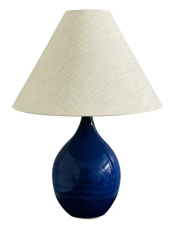 The Scatchard table lamp combines timeless ceramic craftsmanship with a striking imperial blue finish. Its generous 22.5-inch height and cream linen shade create warm, ambient lighting perfect for traditional and coastal-inspired interiors.