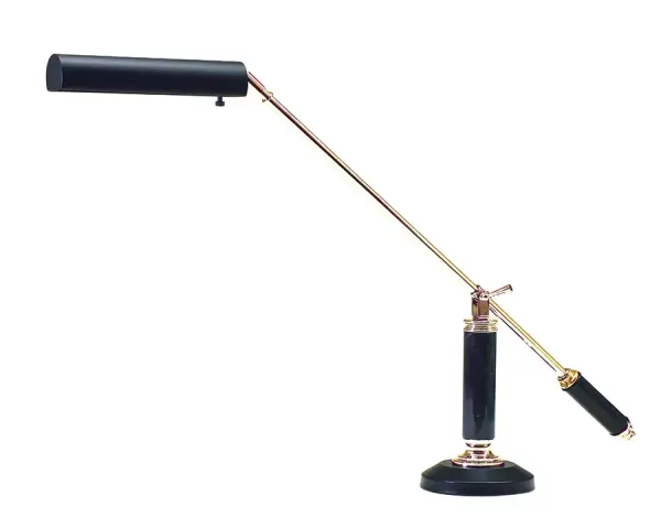 This elegant piano and desk lamp features a sophisticated counter-balance design with polished brass accents and a substantial black marble base. The adjustable arm provides focused task lighting ideal for reading, writing, or piano playing.
