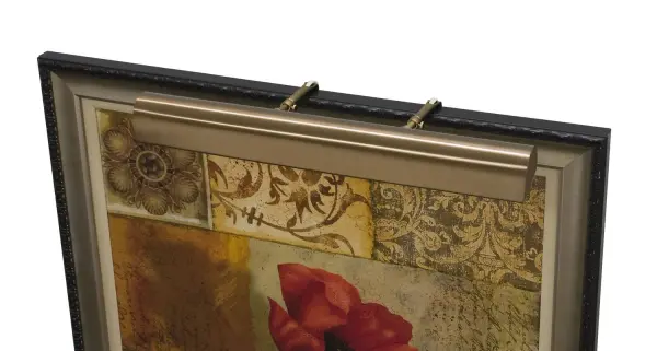 A traditional 21-inch picture light in statuary bronze finish, designed to highlight artwork and framed pieces. Plug-in convenience with California Title 24 compliance makes it practical for residential and commercial applications.