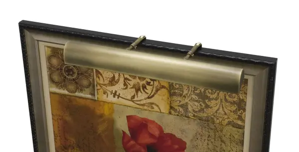 A traditional 21-inch picture light in warm antique brass finish, designed to highlight artwork and framed pieces. The plug-in design offers flexible installation without hardwiring, making it ideal for renters or quick updates.