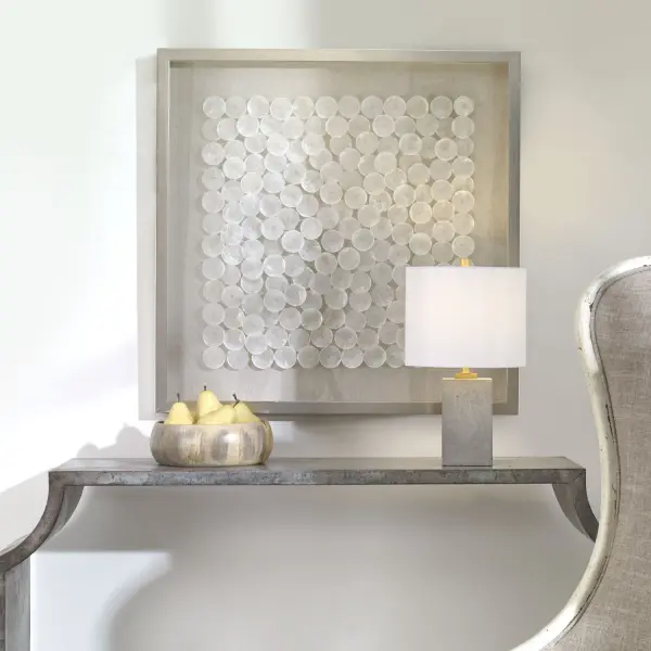 A textured wall art piece featuring natural capiz shell layers over linen in a brushed silver pine frame. Elegant coastal accent for entryways and living spaces.