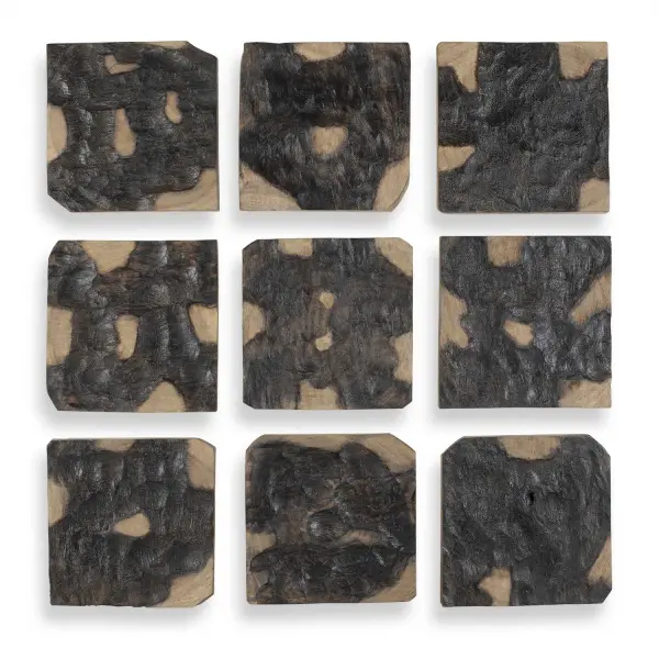A hand-torched Suar wood wall decor set of 9 pieces in black and natural tones, bringing sculptural, artisanal texture to any wall.