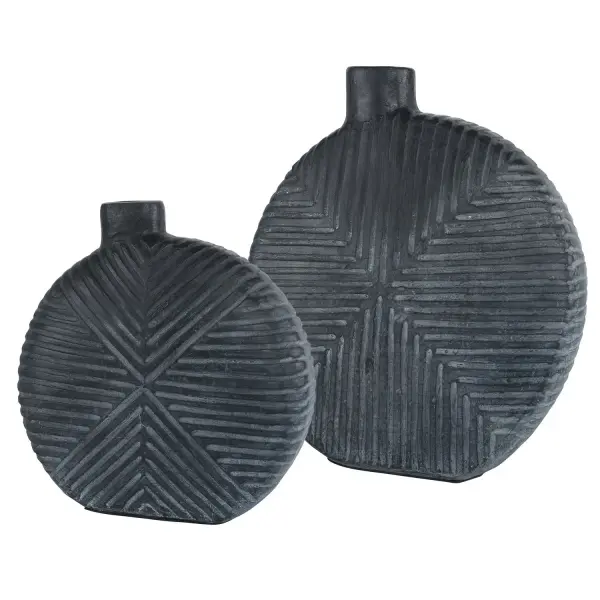 A pair of GRC vases with contemporary geometric carving and off-centered openings in an aged black finish—striking as decor alone or filled with florals.
