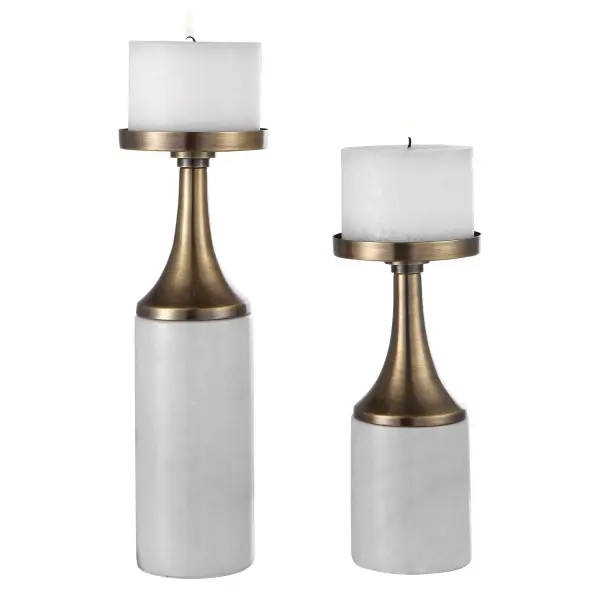 A refined pair of candleholders combining antique brushed brass with white marble feet, complete with matching distressed candles for an instant styled look.