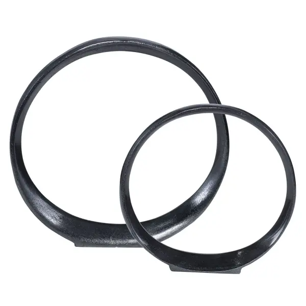 A streamlined set of two aluminum orbit sculptures in a sleek black nickel finish, rated for indoor or outdoor use, adding contemporary polish to any surface.
