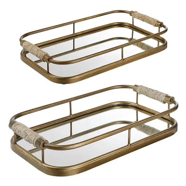 This brushed gold set of two iron trays with rope-wrapped handles and mirrored bottoms brings coastal-modern texture and reflective shine to tabletop styling.