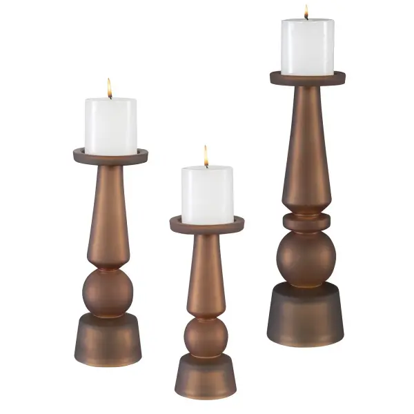 This set of three glass candleholders in a warm butter rum tone offers classic silhouettes and includes matching candles, ready to display right out of the box.