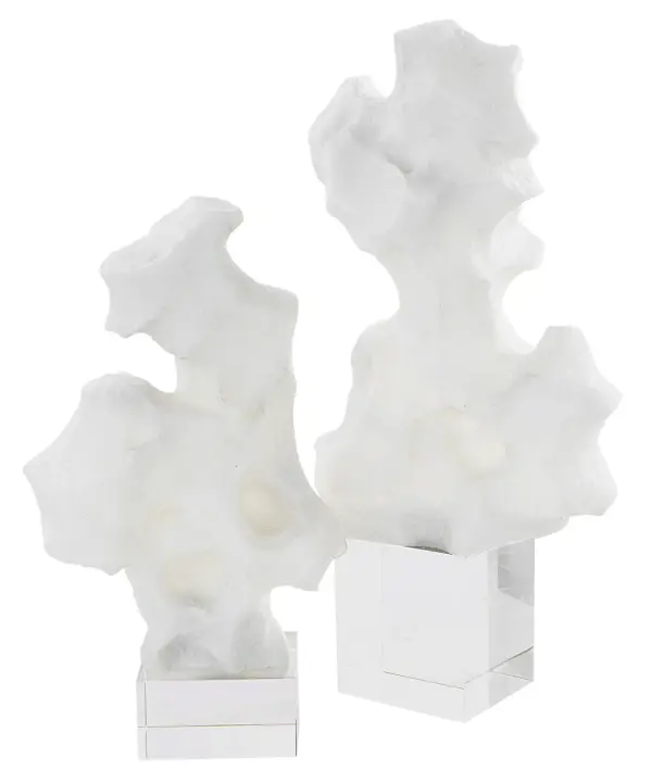 A striking set of two abstract white stone sculptures perched on crystal bases, adding modern texture to any tabletop or shelf display.