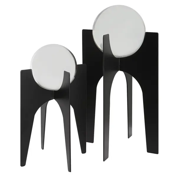A set of two faceted crystal spheres perched on brushed black iron bases, offering an elegant, light-catching accent for shelves, consoles, or tabletops.